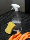 Bathroom cleaning equipment with spray bottle, gloves and a sponge on tile floor Royalty Free Stock Photo
