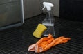 Bathroom cleaning equipment with spray bottle, gloves and a sponge on tile floor Royalty Free Stock Photo