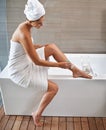 Bathroom, cleaning and woman shaving legs, morning and grooming routine with treatment and hair removal. Person, home Royalty Free Stock Photo