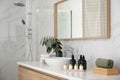 Bathroom counter with stylish vessel sink and toiletries. Interior design
