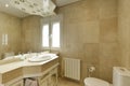 Bathroom with cream marble sink, large frameless wall mirror