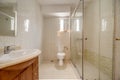 Bathroom decorated with square walk-in shower with cherry wood