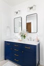 A bathroom detail with a blue cabinet and a white marble countertop. Royalty Free Stock Photo