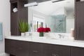 A bathroom detail with a dark wood cabinet and white marble countertop. Royalty Free Stock Photo
