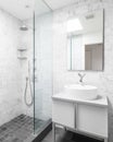 A bathroom detail with marble walls, walk-in shower, and vessel sink. Royalty Free Stock Photo