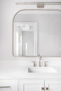 A bathroom detail shot with a white cabinet and bronze faucet. Royalty Free Stock Photo