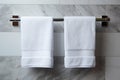 Bathroom elegance White towel hanging in a marble tiled wall bathroom