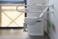 Bathroom equipped with toilet for the elderly and disabled people with fall prevention handle Royalty Free Stock Photo
