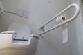 Bathroom equipped with toilet for the elderly and disabled people with fall prevention handle Royalty Free Stock Photo