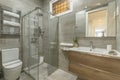 Bathroom with faux marble tile, walk-in shower with sliding glass doors, Royalty Free Stock Photo