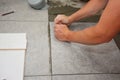 Bathroom flooring works. Worker installing ceramic tile on the floor Royalty Free Stock Photo