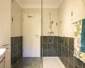 Bathroom with glass shower, tiles green and white. Door is temporary close Royalty Free Stock Photo