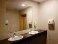 Bathroom interior in black and white. Round ceramic washbasins. Mirrors, plastic soap dish and chrome faucets for washing hands Royalty Free Stock Photo