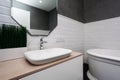 Bathroom interior. Bright bathroom with new tiles. New washbasin, white sink and large mirror. Royalty Free Stock Photo