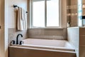 Bathroom interior with built in rectangular bathtub by the sliding glass window Royalty Free Stock Photo