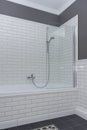 Bathroom interior close-up. The walls are painted gray, covered with decorative ceramic tiles with white glossy bricks. Royalty Free Stock Photo