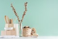 Bathroom interior in green mint menthe with beige wooden organic cosmetic accessories - bath sponge, soap, towel, dried flowers.