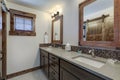 Bathroom interior with grey quarts countertop, two mirrors and barn style doors Royalty Free Stock Photo