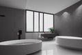 Bathroom interior with large round bathtub with faucet and window.