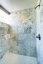 Bathroom interior. Shower cabin with marble tile and small window. Royalty Free Stock Photo