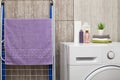 Bathroom, interior, shower set, shampoo, hand and body towels. Washing machine in the bathroom, dryer. Royalty Free Stock Photo