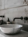 Bathroom interior with stylish black sink and marble washbasin, modern concrete walls Royalty Free Stock Photo