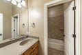 Bathroom interior with white doors and bathtub room with brown tiles corner shelf and surround