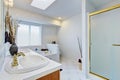 Bathroom interior in white tones with brown cabinets Royalty Free Stock Photo