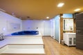 Bathroom with Jacuzzi, white sink, mirrors and showers with glass doors