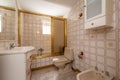 Bathroom with large shower with gold-edged glass partition, mirror