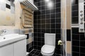 Bathroom with shower, toilet bowl and sink. Hotel standart bedroom. simple and stylish interior. interior lighting