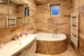 Bathroom in luxury home with bath and furniture Royalty Free Stock Photo