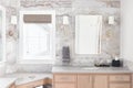 A bathroom with marble tiles on the wall and wood cabinet. Royalty Free Stock Photo