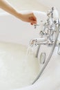Bathroom with milk. Female hand opening water in bathroom. Hugiene concept. Royalty Free Stock Photo