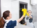 Bathroom mirror being wiped down by maid