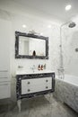 Bathroom with mirror, marble tiles, luxurius wardrobe, sink and faucet Royalty Free Stock Photo