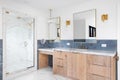 A bathroom with a natural wood cabinet and blue tiles. Royalty Free Stock Photo