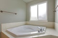 Bathroom nook features white corner tub