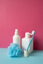 Bathroom object. Shampoo and soap dispenser, toothbrush, shower ball on skyblue shelf. pink wall background Royalty Free Stock Photo