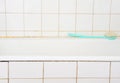 Old bathroom with bathtub and white tiles Royalty Free Stock Photo