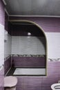 The bathroom is in pink and white tiles and with an arch to the washing booth Royalty Free Stock Photo