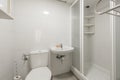 Bathroom with porcelain wall-hung sink, square frameless mirror,