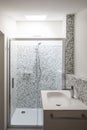Bathroom renovated with mosaic of grey tiles. Washbasin, shower and skylight Royalty Free Stock Photo