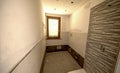 Bathroom after renovation. New stone tiles on the bath room floor.  Home renovation and improvement concept Royalty Free Stock Photo