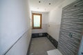 Bathroom after renovation. New stone tiles on the bath room floor.  Home renovation and improvement concept Royalty Free Stock Photo