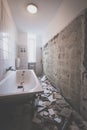 Bathroom renovation - removing tiles in old apartment bathroom Royalty Free Stock Photo