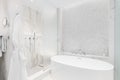 A bathroom\'s soaking tub and marble walk-in shower.