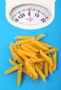 Bathroom scale with italian pasta Royalty Free Stock Photo