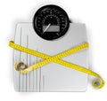 Bathroom scale with a measuring tape on background Royalty Free Stock Photo
