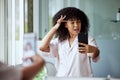 Bathroom selfie, beauty influencer and black woman doing skincare, house facial and social media. Wellness, morning self